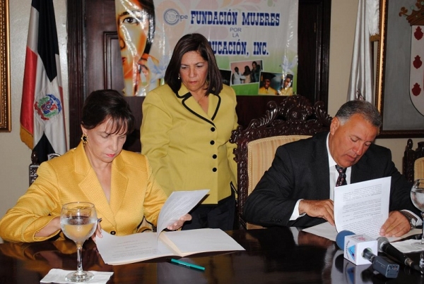 El alcalde Gilberto Serulle y Peggy Cabral viuda Peña Gómez al momento de firmar el acuerdo, Cabildo – FUNMUJER, presente la concejal Daysi Díaz. 