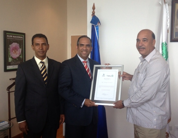 El Secretario Ejecutivo de la Unidad Municipal de Programas Especiales (UMPE), de la LMD, Víctor Féliz, recibe el reconocimiento de manos del Ministro de Medio Ambiente Bautista Rojas Gómez, observa Domingo Contreras.